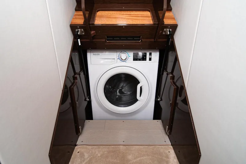 Slide: The Image of Compact laundry area in 2023 Prestige 520 yacht with modern washing machine. - 59