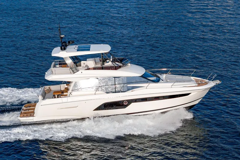 Slide: The Image of 2023 Prestige 520 yacht cruising on open water, showcasing luxury design and performance. - 6