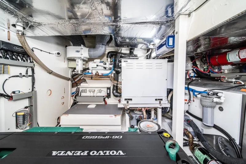 Slide: The Image of Engine room of 2023 Prestige 520 yacht, featuring Volvo Penta components and advanced systems. - 65