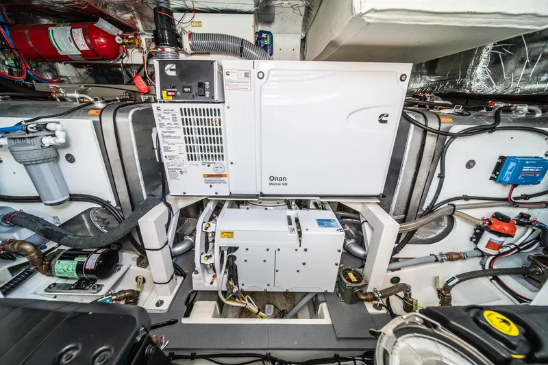 Slide: The Image of Engine room of 2023 Prestige 520 yacht with Onan generator and various equipment. - 66