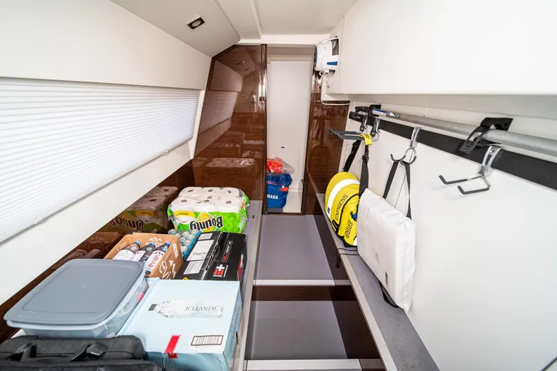 Slide: The Image of Storage area in a 2023 Prestige 520 yacht, featuring supplies and organized equipment. - 70