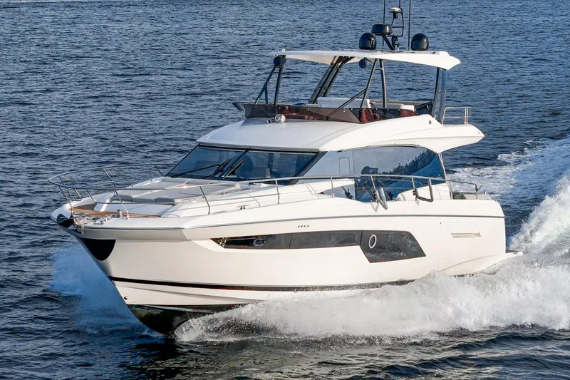 Slide: The Image of 2023 Prestige 520 yacht cruising on open water, showcasing sleek design and luxury features. - 8