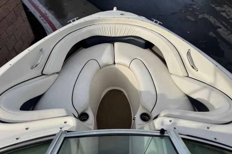 Slide: The Image of 2006 Sea Ray 220 Select boat interior with white cushioned seating. - 11