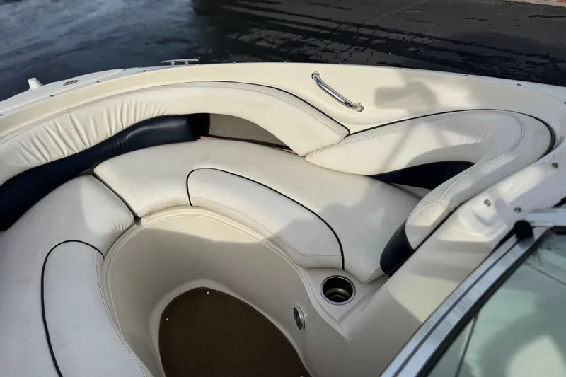Slide: The Image of 2006 Sea Ray 220 Select boat interior with white cushioned seating and cup holder. - 13