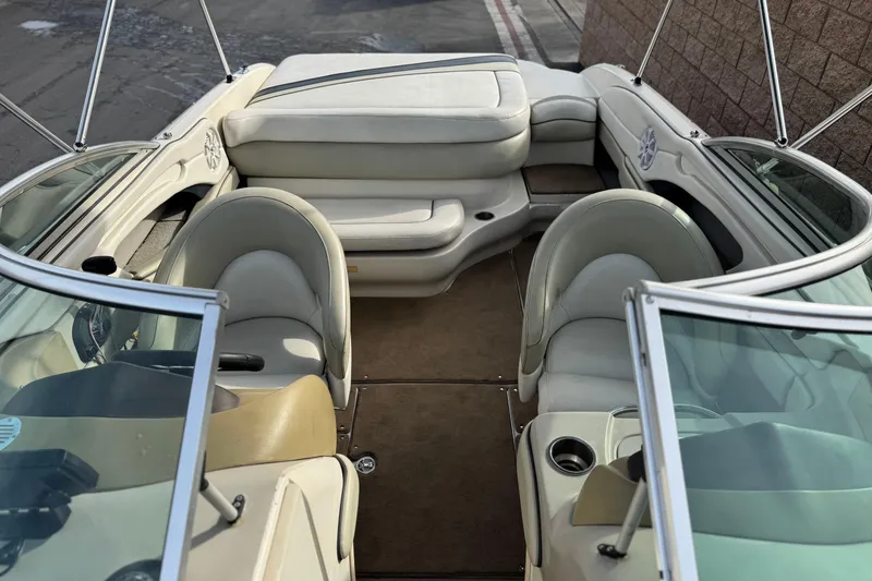 Slide: The Image of 2006 Sea Ray 220 Select boat interior with beige seating and carpeted floor. - 14