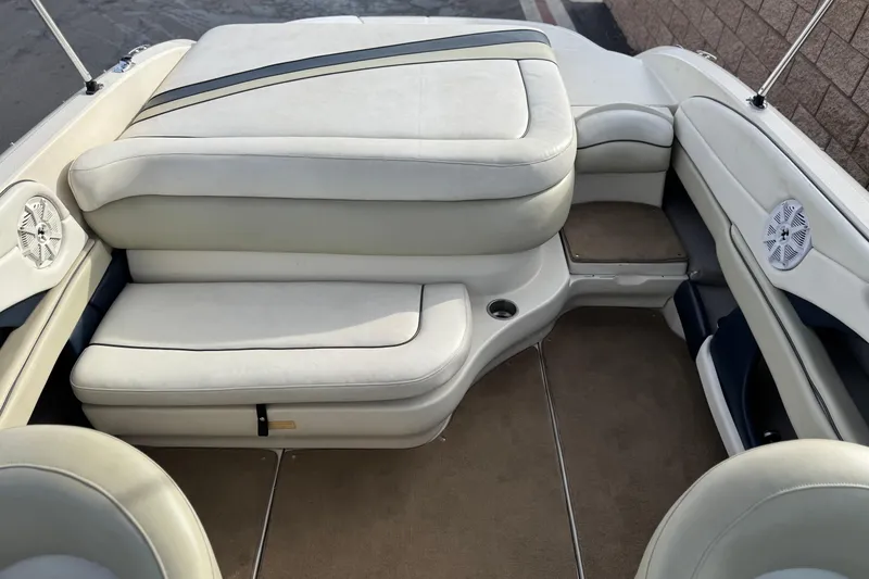 Slide: The Image of 2006 Sea Ray 220 Select boat interior with beige seating and carpeted flooring. - 15
