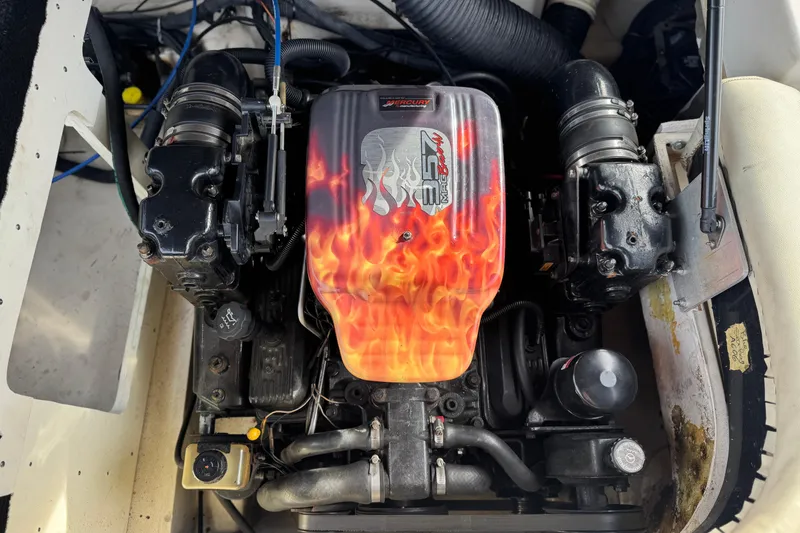 Slide: The Image of Engine of a 2006 Sea Ray 220 Select boat with flame design cover. - 18