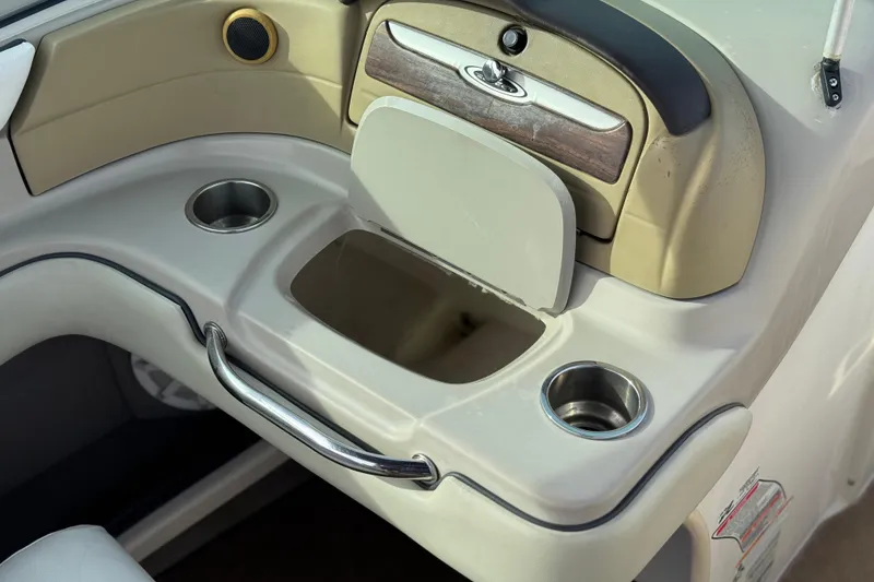 Slide: The Image of 2006 Sea Ray 220 Select boat interior with cup holders and storage compartment. - 21