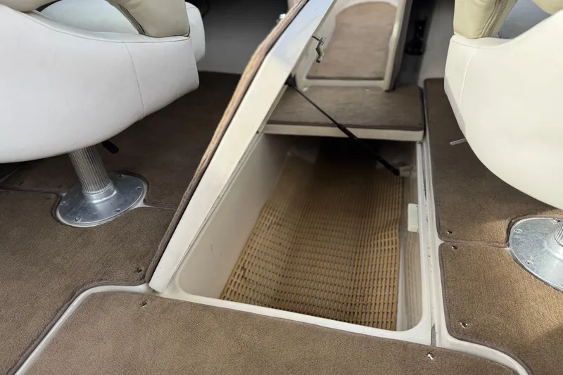 Slide: The Image of 2006 Sea Ray 220 Select boat interior with open storage compartment and seating. - 22