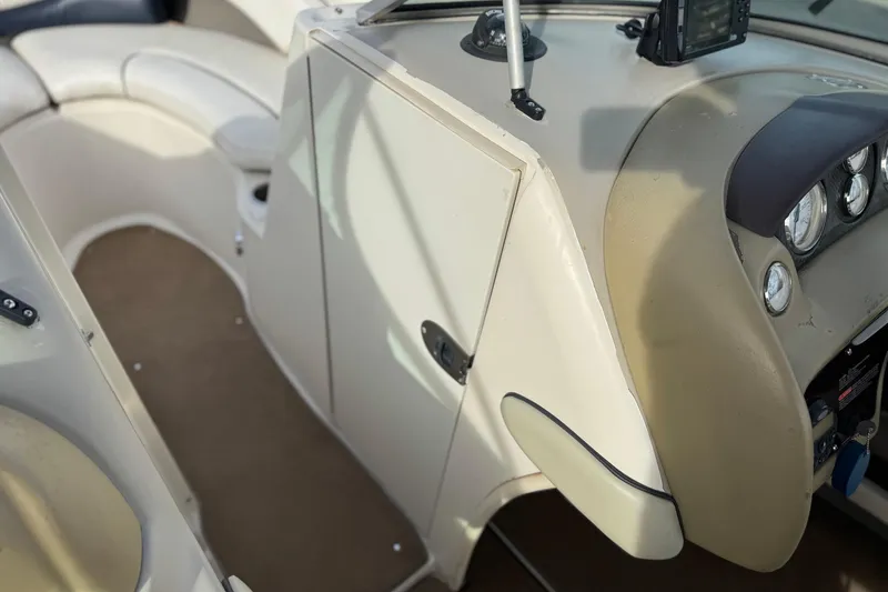 Slide: The Image of 2006 Sea Ray 220 Select boat interior with beige seating and dashboard controls. - 27