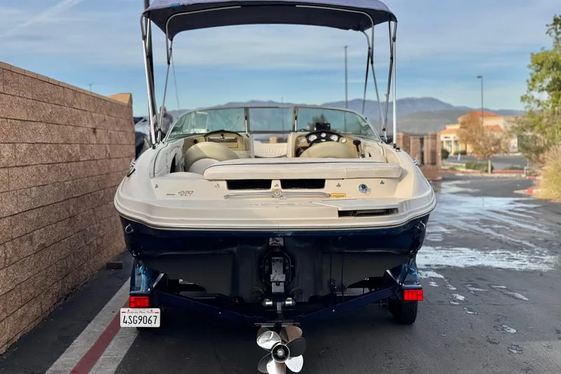 Slide: The Image of 2006 Sea Ray 220 Select boat on trailer, rear view, parked outdoors. - 4