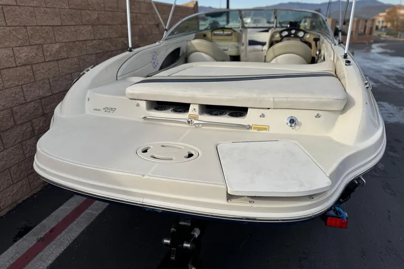 Slide: The Image of 2006 Sea Ray 220 Select boat, rear view, showcasing seating and deck features. - 6