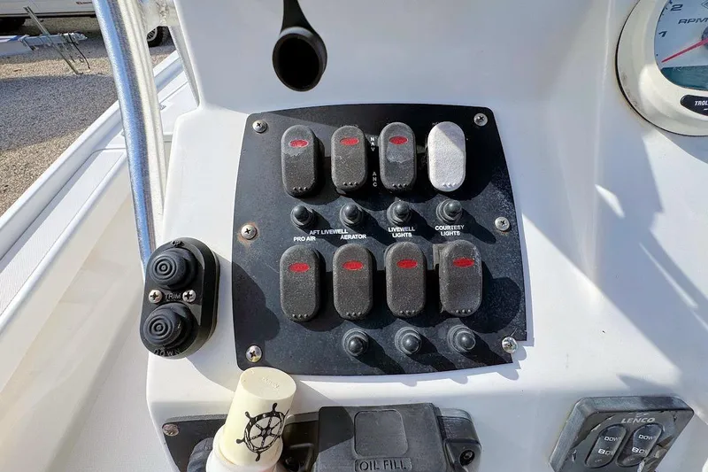 Slide: The Image of Control panel of a 2019 Mako 21 LTS boat with various switches and buttons. - 10