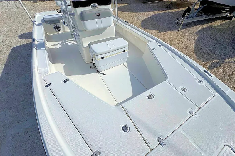 Slide: The Image of 2019 Mako 21 LTS boat interior with seating and storage compartments. - 12