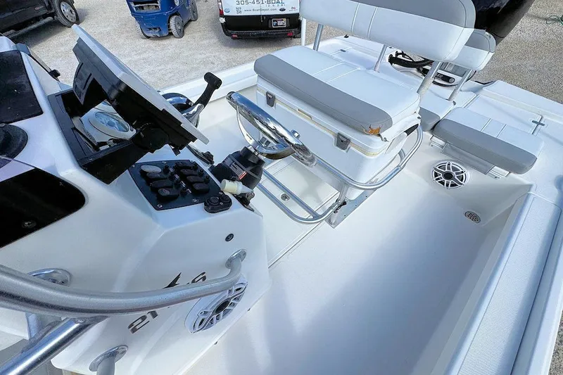 Slide: The Image of 2019 Mako 21 LTS boat interior with steering console and seating. - 5