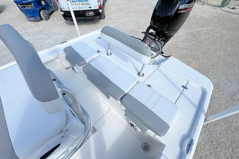Slide: The Image of 2019 Mako 21 LTS boat interior with seating and Mercury outboard motor. - 6