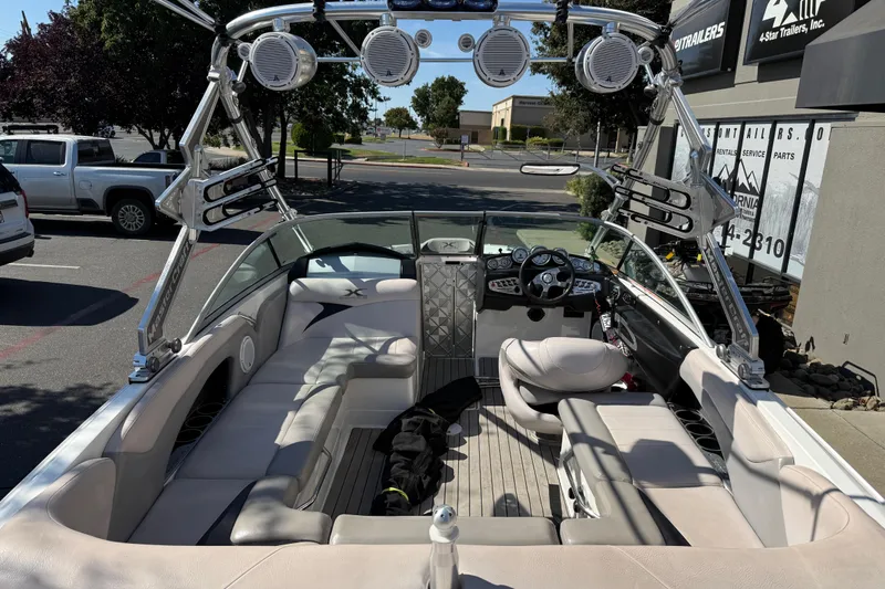 Slide: The Image of 2007 MasterCraft X-15 boat interior with seating, speakers, and control panel in a parking lot. - 12