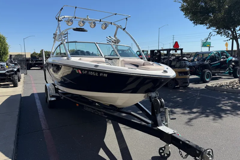 Slide: The Image of 2007 MasterCraft X-15 boat on trailer in parking lot, sunny day. - 6