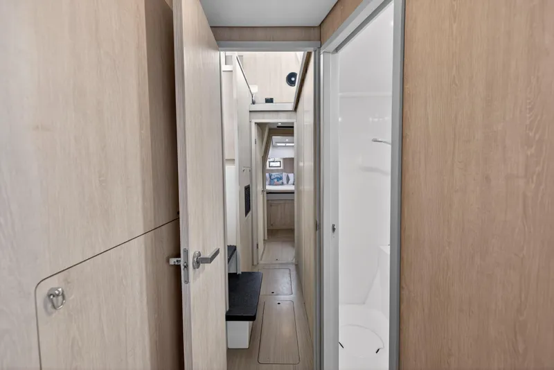 Slide: The Image of Interior hallway of 2016 Leopard 51 Powercat yacht, featuring wood paneling and modern design. - 110