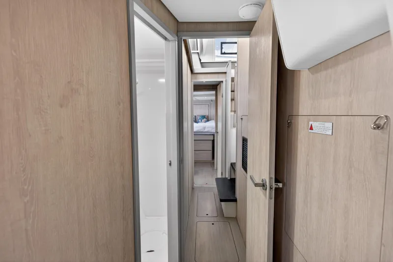 Slide: The Image of Interior hallway of 2016 Leopard 51 Powercat yacht, featuring modern wood paneling. - 117
