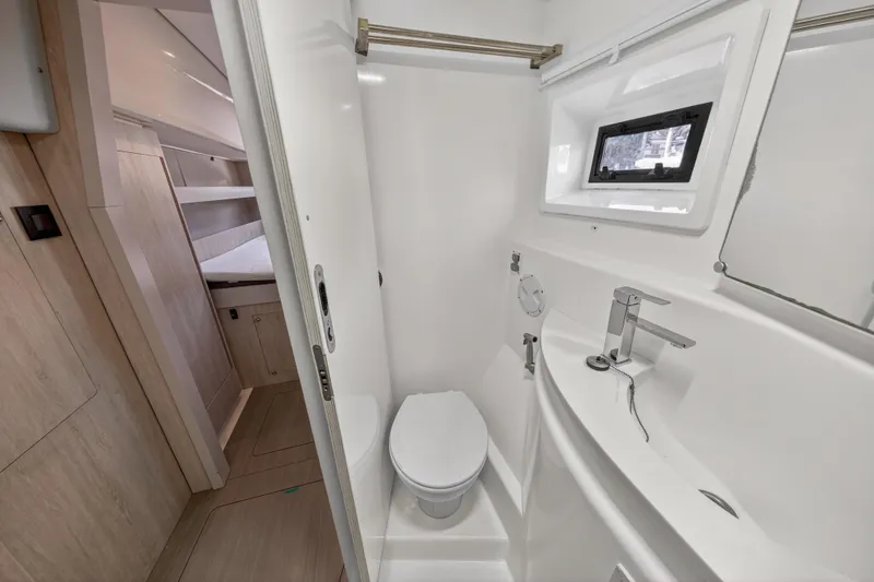 Slide: The Image of Compact bathroom in 2016 Leopard 51 Powercat, featuring modern fixtures and a small window. - 119