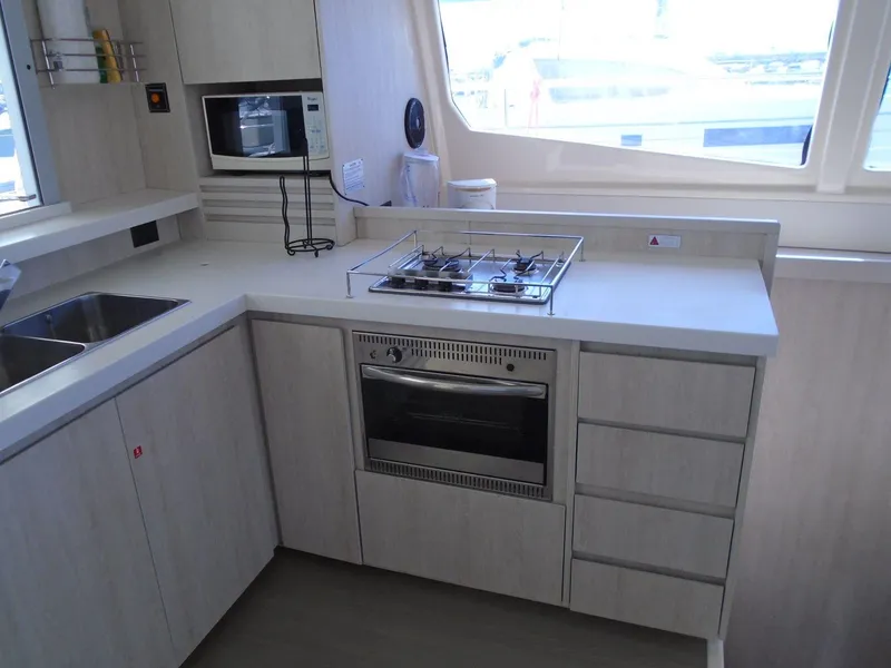 Slide: The Image of 2016 Leopard 51 Powercat interior with seating area and table, featuring modern design. - 12