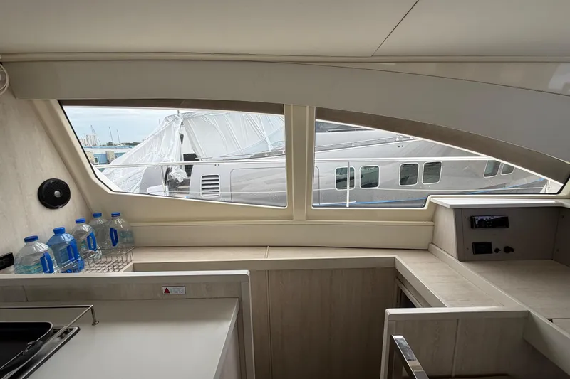 Slide: The Image of Interior view of 2016 Leopard 51 Powercat yacht with window and water bottles. - 18