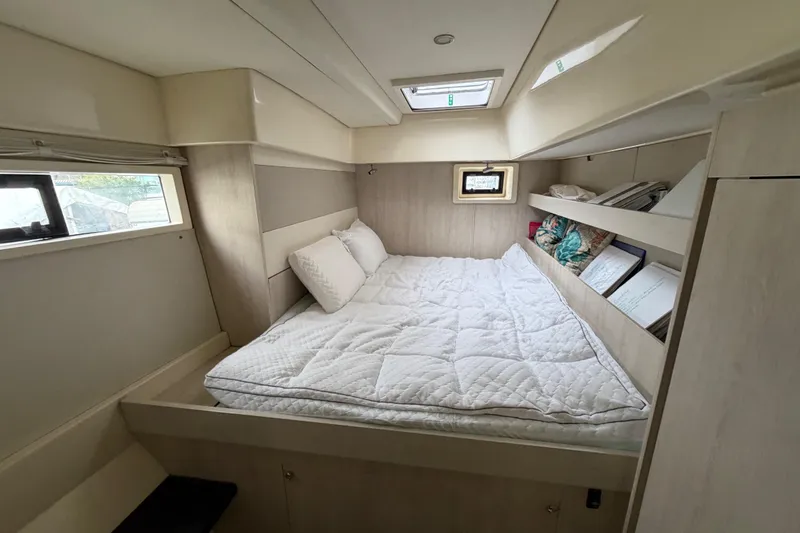 Slide: The Image of Cozy bedroom interior of 2016 Leopard 51 Powercat with bed, pillows, and shelves. - 21