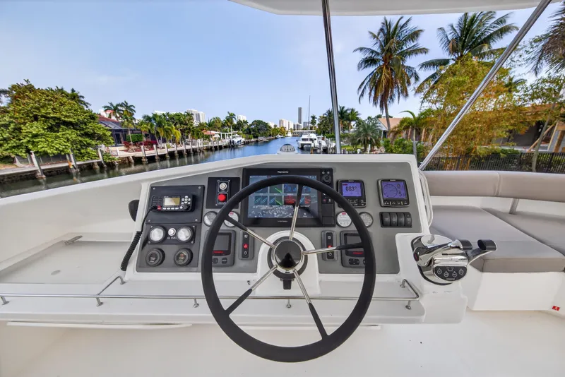 Slide: The Image of Helm of 2016 Leopard 51 Powercat with modern controls and scenic waterway view. - 34