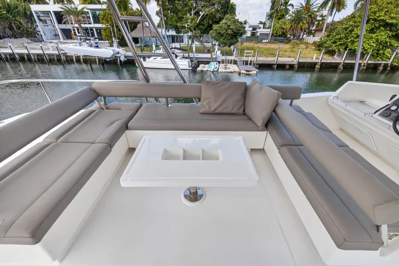 Slide: The Image of Luxurious seating area on 2016 Leopard 51 Powercat yacht, docked by a serene waterfront. - 38