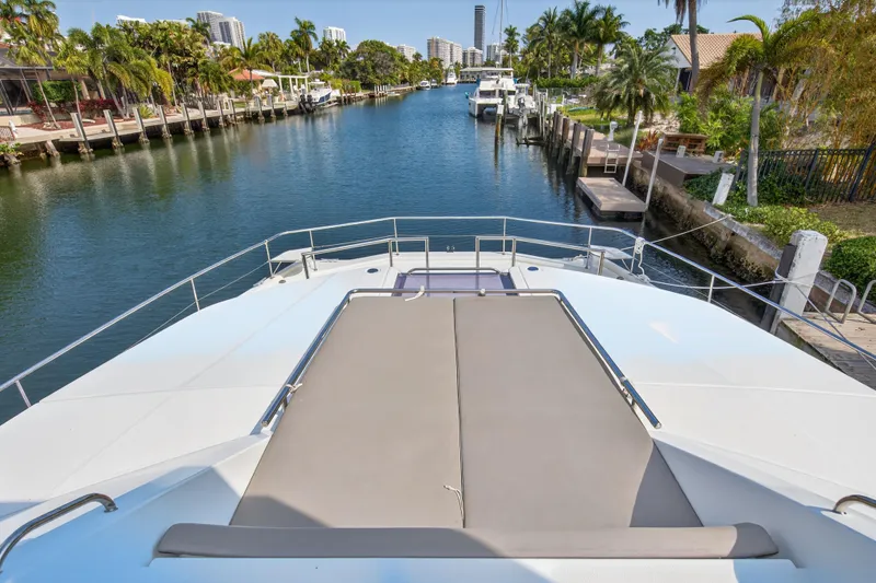 Slide: The Image of 2016 Leopard 51 Powercat yacht on a serene canal with lush palm trees. - 48