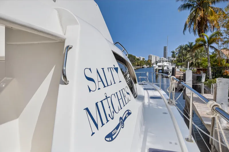 Slide: The Image of 2016 Leopard 51 Powercat yacht docked in sunny marina with palm trees. - 49