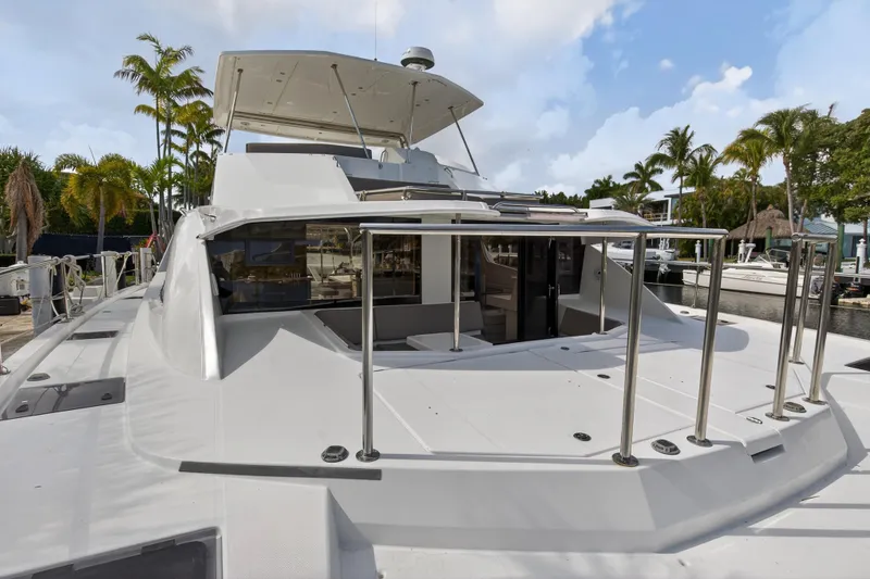 Slide: The Image of 2016 Leopard 51 Powercat yacht docked, featuring spacious deck and modern design. - 51