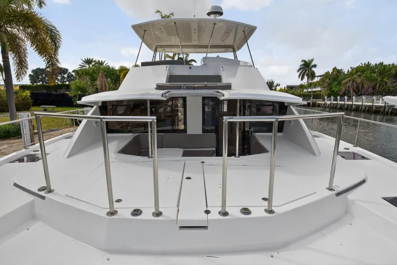 Slide: The Image of 2016 Leopard 51 Powercat yacht docked, showcasing spacious deck and sleek design. - 52
