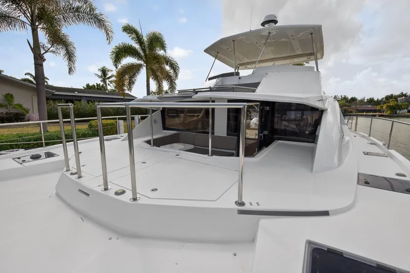 Slide: The Image of 2016 Leopard 51 Powercat yacht with spacious deck and modern design, docked near palm trees. - 53