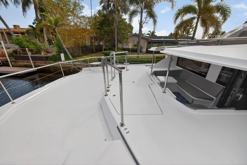 Slide: The Image of 2016 Leopard 51 Powercat yacht deck with seating, surrounded by tropical greenery. - 54