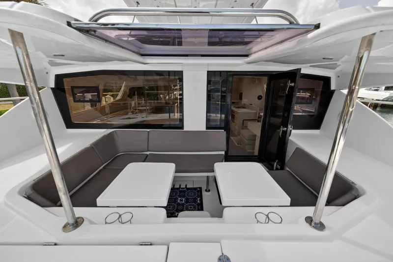 Slide: The Image of 2016 Leopard 51 Powercat interior with seating area and tables, showcasing modern design. - 57