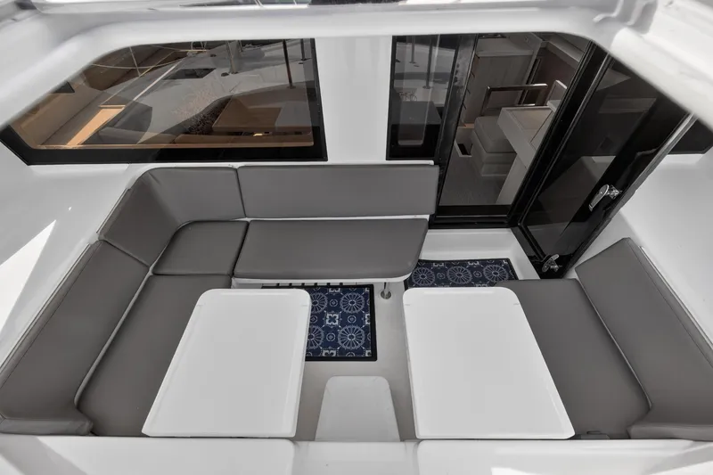 Slide: The Image of 2016 Leopard 51 Powercat interior with gray seating and white tables. - 60
