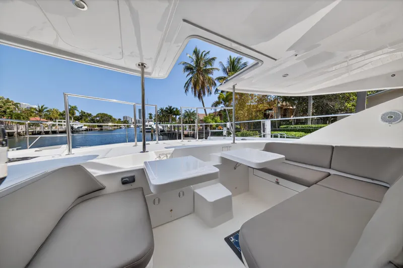Slide: The Image of 2016 Leopard 51 Powercat yacht interior with seating, table, and waterfront view. - 62