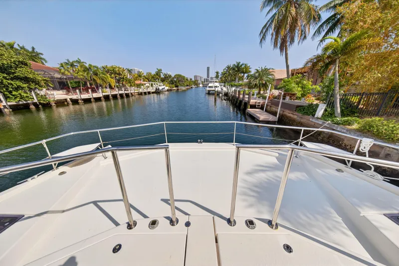Slide: The Image of 2016 Leopard 51 Powercat on a scenic canal with palm trees and waterfront homes. - 63