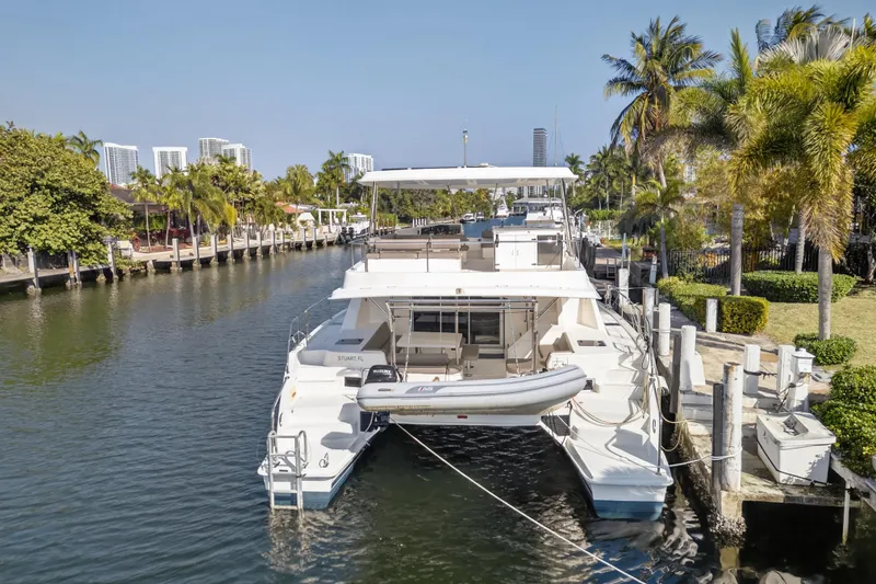 Slide: The Image of 2016 Leopard 51 Powercat docked in a scenic canal with palm trees and buildings. - 69