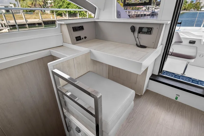Slide: The Image of Interior of 2016 Leopard 51 Powercat with seating and control panel, overlooking marina. - 85