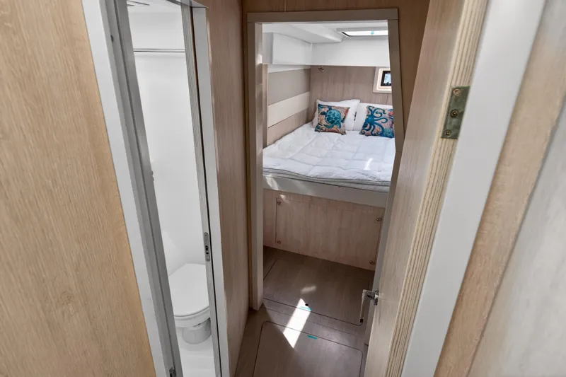 Slide: The Image of Interior of 2016 Leopard 51 Powercat, featuring cozy bedroom and compact bathroom. - 92