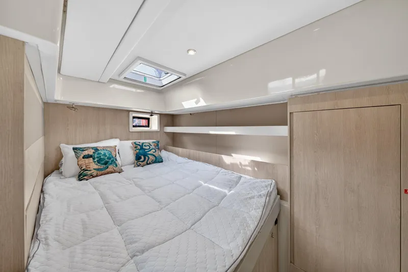 Slide: The Image of Luxurious cabin interior of 2016 Leopard 51 Powercat with cozy bedding and natural light. - 94