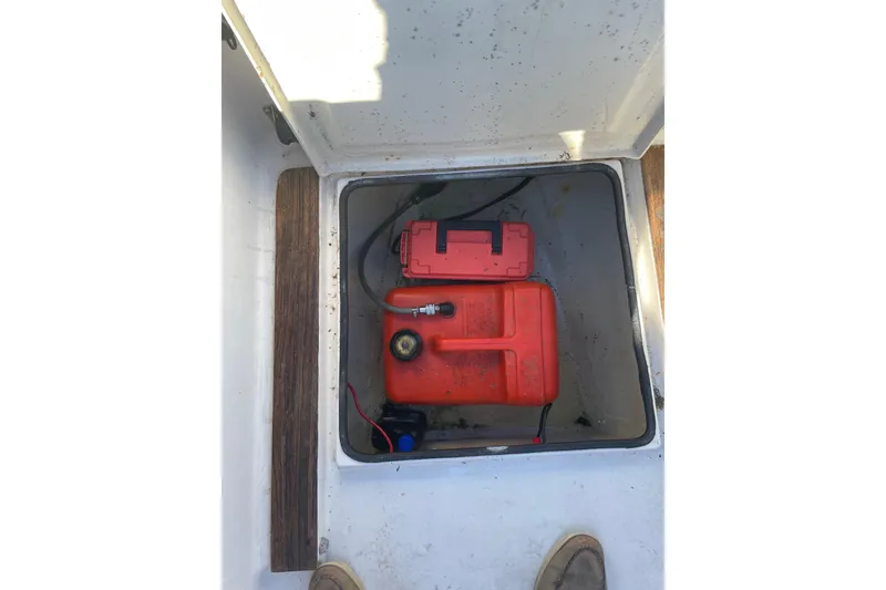 Slide: The Image of Open storage compartment with red fuel tank and battery in Dragonfly 800 Swing Wing, 1992 model. - 13