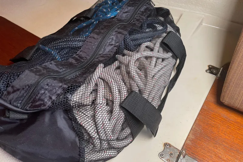 Slide: The Image of Mesh bag with coiled ropes inside, placed on a wooden surface. - 18