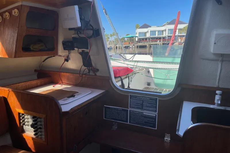 Slide: The Image of Interior of a 1992 Dragonfly 800 Swing Wing sailboat with navigation equipment and marina view. - 20