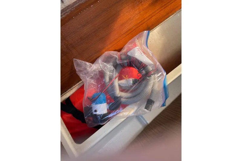 Slide: The Image of Plastic bag with coiled hose and accessories inside a Dragonfly 800 Swing Wing, 1992 model. - 21