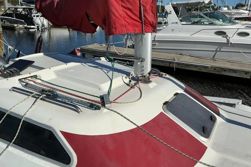 Slide: The Image of Close-up of a 1992 Dragonfly 800 Swing Wing sailboat deck with red sail cover. - 24