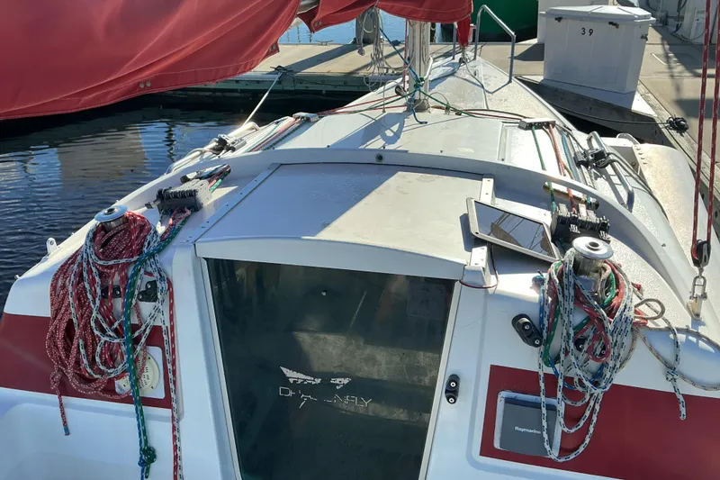 Slide: The Image of Sailboat cockpit of 1992 Dragonfly 800 Swing Wing with ropes and equipment. - 28